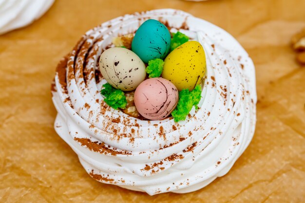 Mini nido de merengue Pavlova con huevos, dulces de pascua