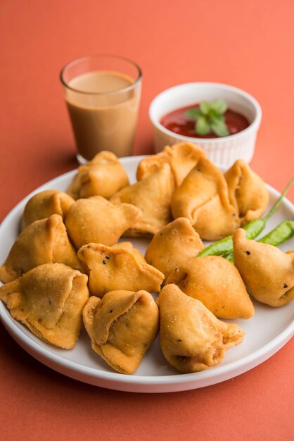 Mini o pequeña samosa con salsa y té caliente