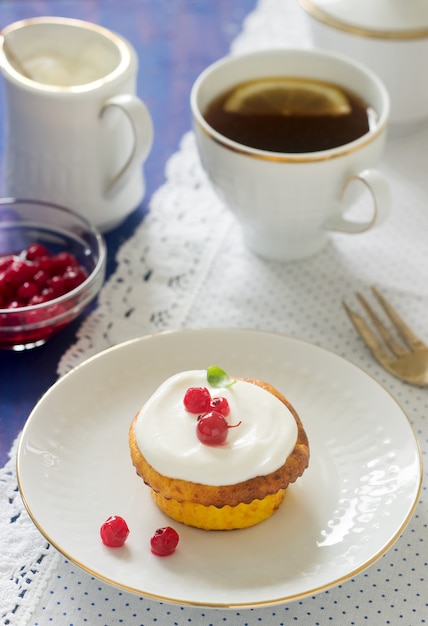 Mini tarta de queso con crema batida y grosella roja. Estilo rústico