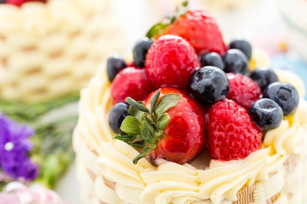 Mini tortas de canasta de Pascua con fruta fresca glaseada en la parte superior.