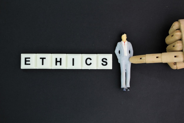Miniaturmenschen mit dem Wort Ethik, dem Konzept der Ethik in der Arbeit oder der Ethik in der Industrie