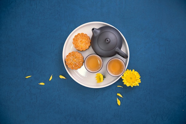 Minimale Einfachheit Layout Mondkuchen auf blauem Hintergrund für MidAutumn Festival kreatives Food-Design-Konzept Draufsicht flach liegend kopieren Raum