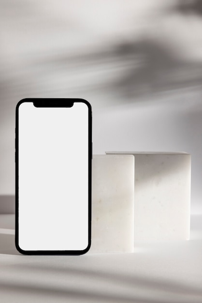 Foto minimalistische anordnung von smartphone und felsen