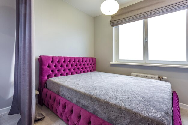MINSK BIELORRÚSSIA SETEMBRO DE 2019 Interior do quarto moderno em estúdios com sofá de cama dupla e almofadas azuis