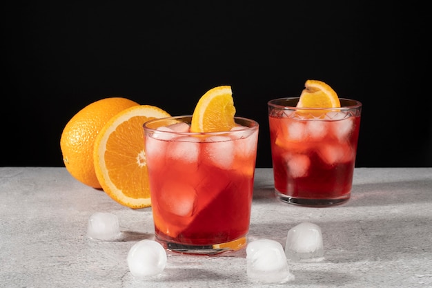 Foto mischung aus cocktails in gläsern mit eiswürfeln und orangenscheiben