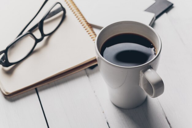 Mistura de material de escritório e gadgets em uma mesa de madeira