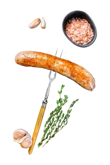 Mit Gewürzen und Kräutern gebratene Wurst vom Grill auf einer Fleischgabel isoliert auf weißem Hintergrund, Ansicht von oben