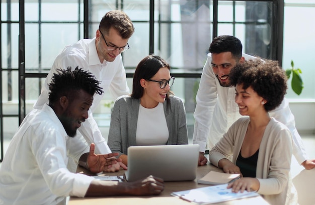 Mitarbeiter, die gemeinsam am Computer arbeiten und Inhalte diskutieren