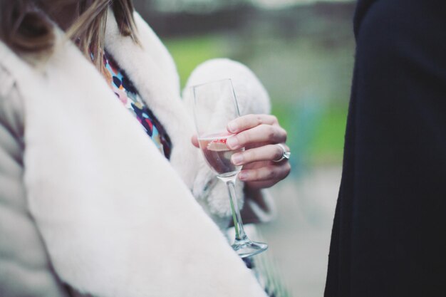 Foto mittelabschnitt einer frau, die champagner bei einer party trinkt