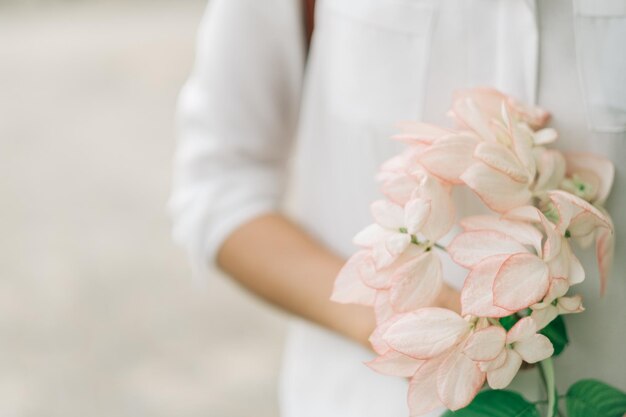 Mittelabschnitt einer Frau, die einen Blumenstrauß hält