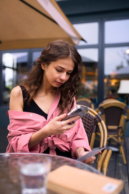 Foto mittlere schussfrau, die smartphone hält