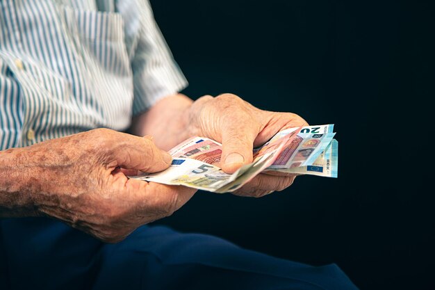 Foto mittlerer abschnitt eines älteren mannes, der im freien papiergeld zählt