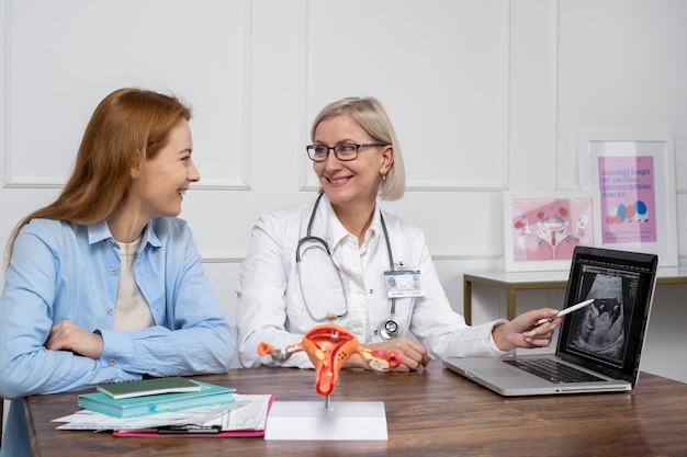 Mittlerer Schuss Smiley-Arzt im Gespräch mit dem Patienten