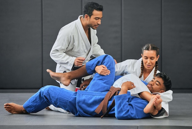 Mma artes marciales y ejercicio con un profesor entrenador o instructor que instruye a los estudiantes durante el entrenamiento de práctica o combate en un gimnasio o dojo Clase de lucha y defensa personal para la salud y el estado físico