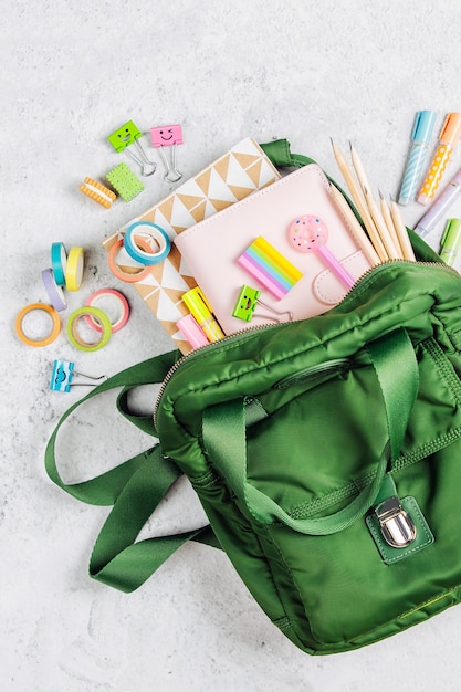 Mochila com material escolar e livros para estudar. De volta ao conceito de escola. Camada plana, vista superior