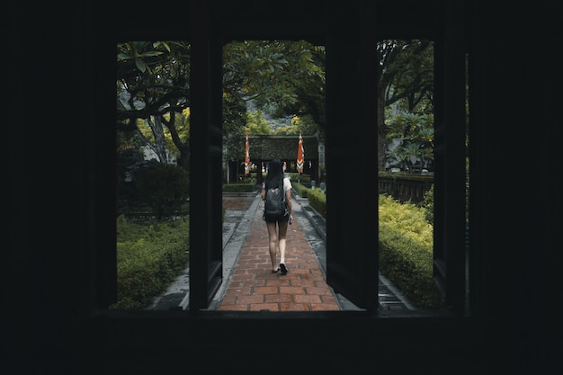 Mochileiro de mulher, explorando um templo no vietnã