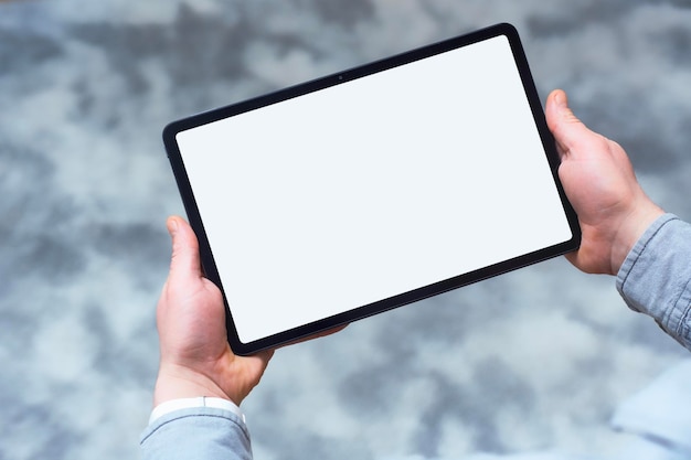 mockup of modern tablet with white blank screen in hand concept for digital design and presentation