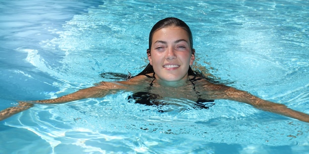 Modefoto von sexy schönem Mädchen im eleganten Bikini, der sich im Schwimmbad entspannt