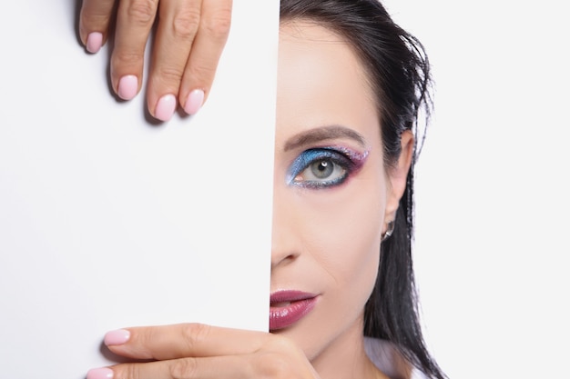 Modell mit farbigem Augen Make-up perfekte halbe Gesichtshaut mit weißer Kartenvorlage modisch