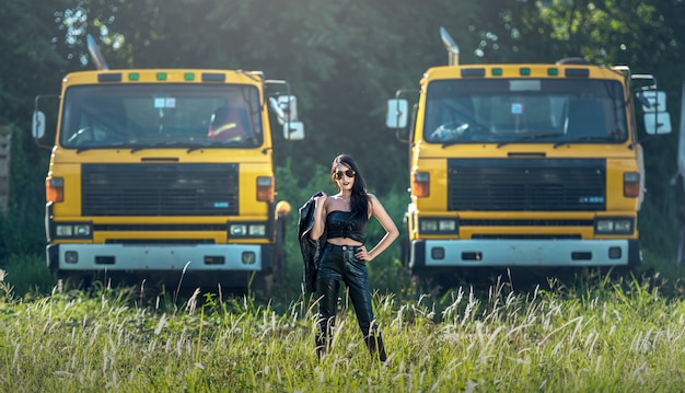 Modelo asiático posando com caminhão em um ambiente ao ar livre