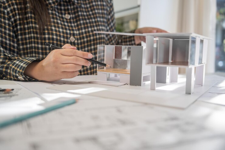 Foto modelo de casa em buleprint desenho de construção e equipamento de desenho estacionário arquiteto analisando modelo de casa casa moderna em mão arquiteto design