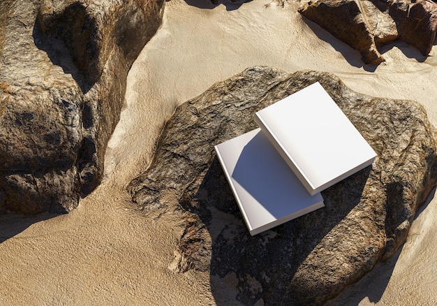 Modelo de livro em branco colocado em pedras na areia, maquete de notebook, maquete no fundo da natureza 02