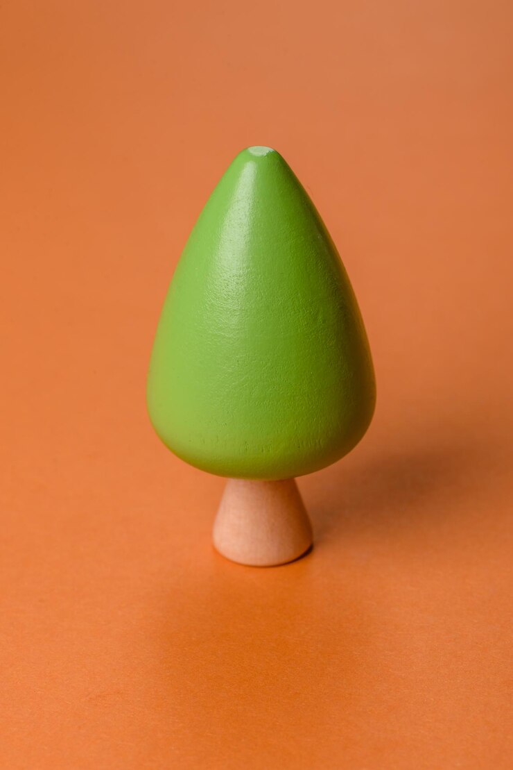 Foto modelo de madeira de uma árvore com uma coroa e um tronco verdes em um fundo laranja