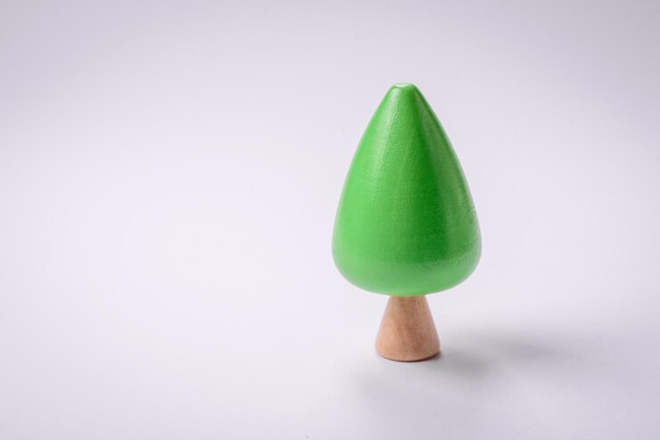 Foto modelo de madeira de uma árvore com uma coroa e um tronco verdes sobre um fundo branco