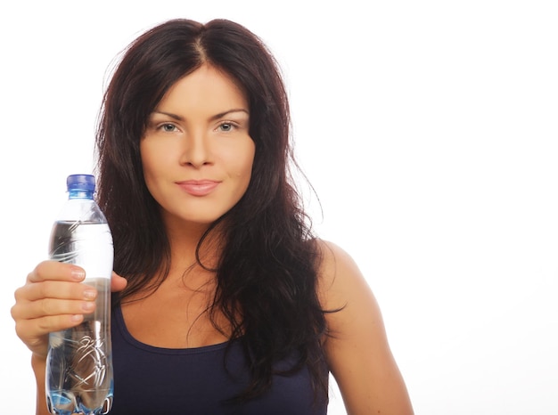 Modelo femenino de la aptitud que sostiene una botella de agua