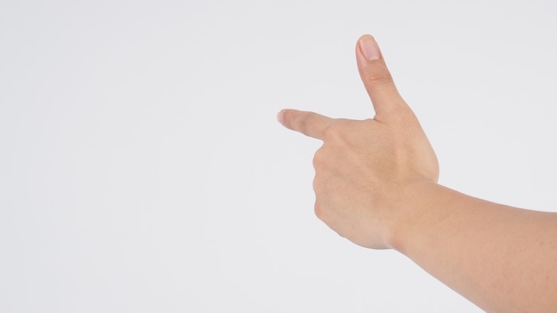 El modelo masculino es señalar con el dedo con la mano izquierda para hacer el signo sobre fondo blanco.