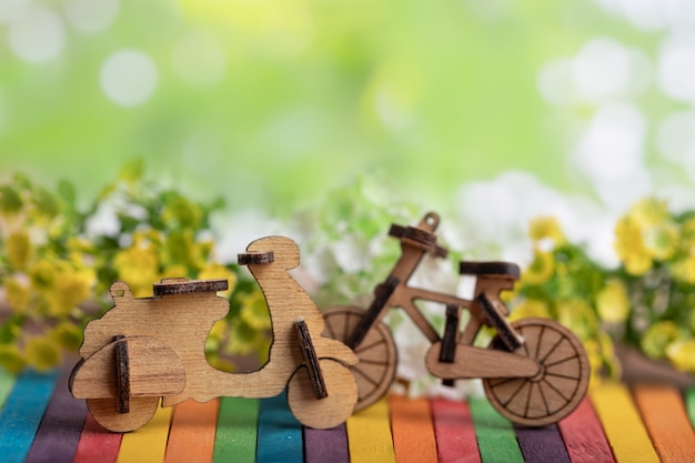 Foto modelo de motocicleta y bicicleta de madera en madera colorida
