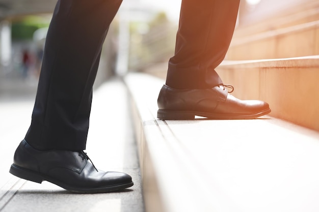 Foto moderner geschäftsmann arbeitet nahaufnahme beine gehen die treppe in der modernen stadt in der hauptverkehrszeit zur arbeit im büro in eile während des ersten morgens der arbeit treppe weichen fokus