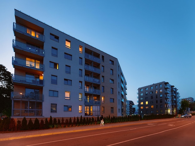 Modernes Mehrfamilienhaus Gebäude Architekturkonzept. Wohnheimanlagen im Freien. Nachts