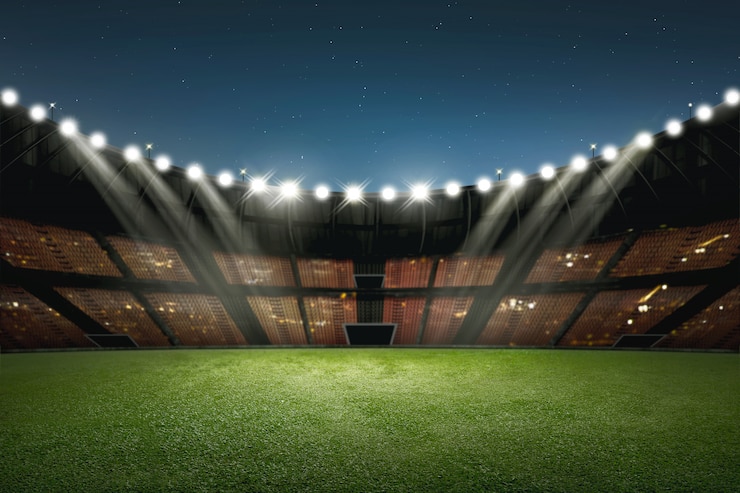 Foto moderno edificio de estadio de fútbol con iluminación.