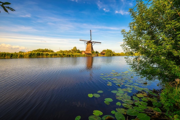 Moinho de vento histórico e um rio fluindo em Kinderdijk Holanda