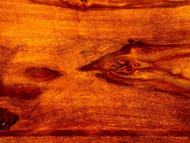 Foto esa moldura de madera de acacia con fondo de madera roja palisandro