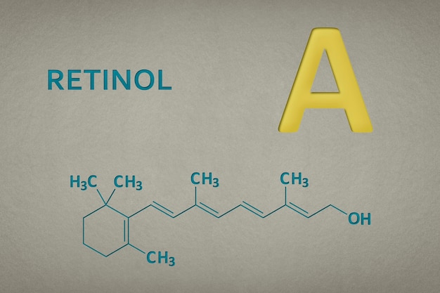 Foto molécula de vitamina a retinol d na fórmula esquelética de fundo de textura de papel de vitamina um texto em recesso