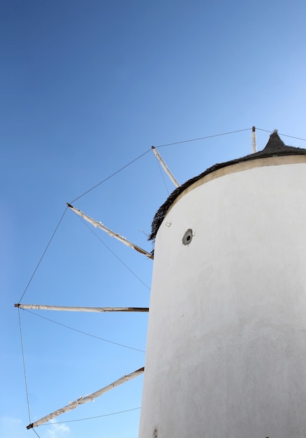 Foto molino de viento famoso griego de santorini en el cielo azul brillante.