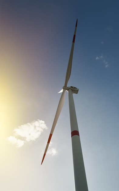 Molino de viento frente al cielo azul que representa energía sostenible y renovable