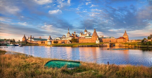 Monasterio Solovetsky en las Islas Solovetsky, el agua azul de la Bahía de la Prosperidad y un barco volcado