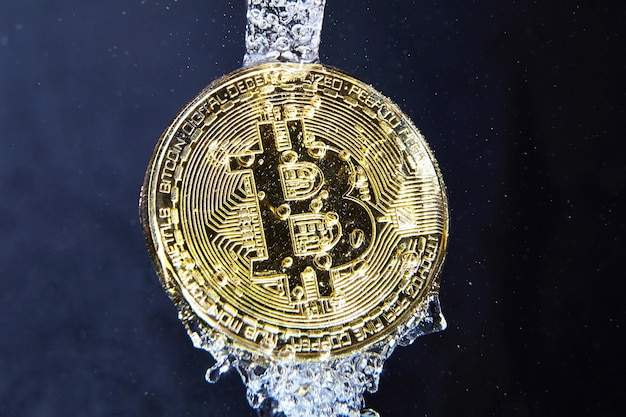 Moneda Bitcoin en concepto de lavado de dinero de salpicaduras de agua