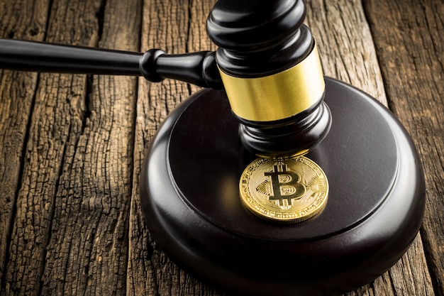 Moneda dorada de bitcoin con el concepto de fondo de juez Juez Wood Hammer Law