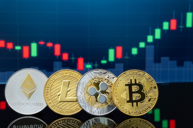 Monedas de Bitcoin de metal físico con gráfico de precios de mercado de intercambio de comercio global en el fondo.