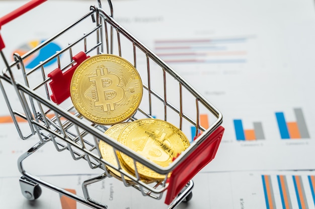 Monedas de oro bitcoin en mini carro de compras