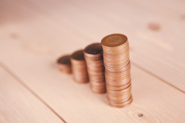 Foto monedas sobre la mesa en forma de gráfico creciente