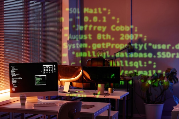 Monitor de computador com dados decodificados na tela em pé na mesa no escritório moderno ou escritório de programadores de diversidade