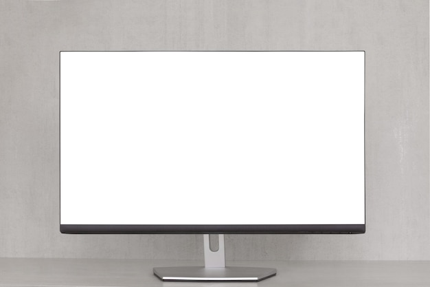 Foto monitoreo de computadora con una pantalla blanca sobre un fondo gris