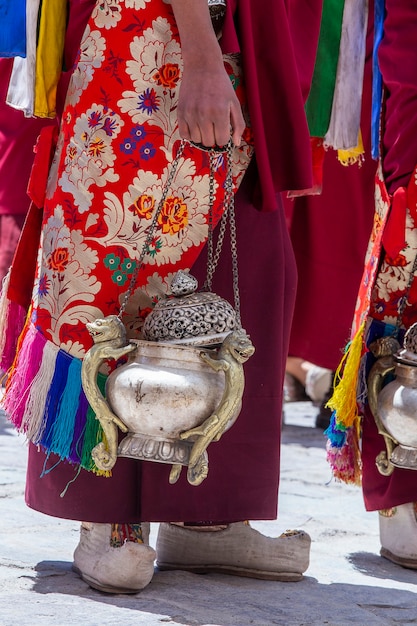 Monje tibetano sostiene un incensario, un recipiente de metal para fumar incienso, durante el culto en un festival budista en el monasterio de Hemis, cerca de Leh, Ladakh, en el norte de la India, cerrar
