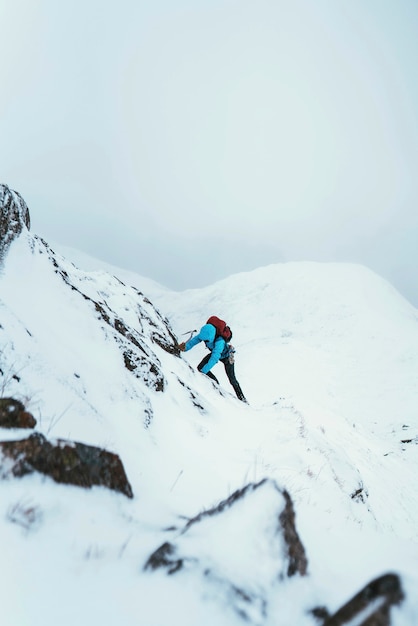 Montañero con un piolet para escalar Forcan Ridge en Glen Shiel, Escocia