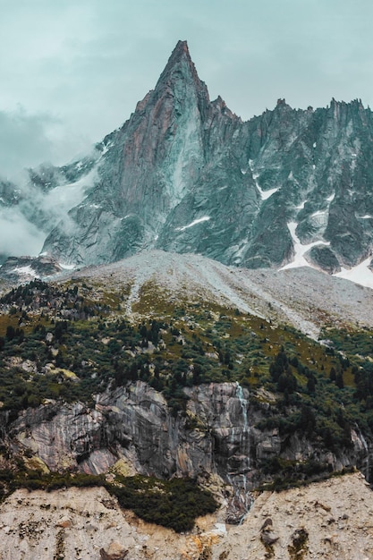 Montanhas na paisagem de Chamonix com nuvens e floresta nos Alpes franceses